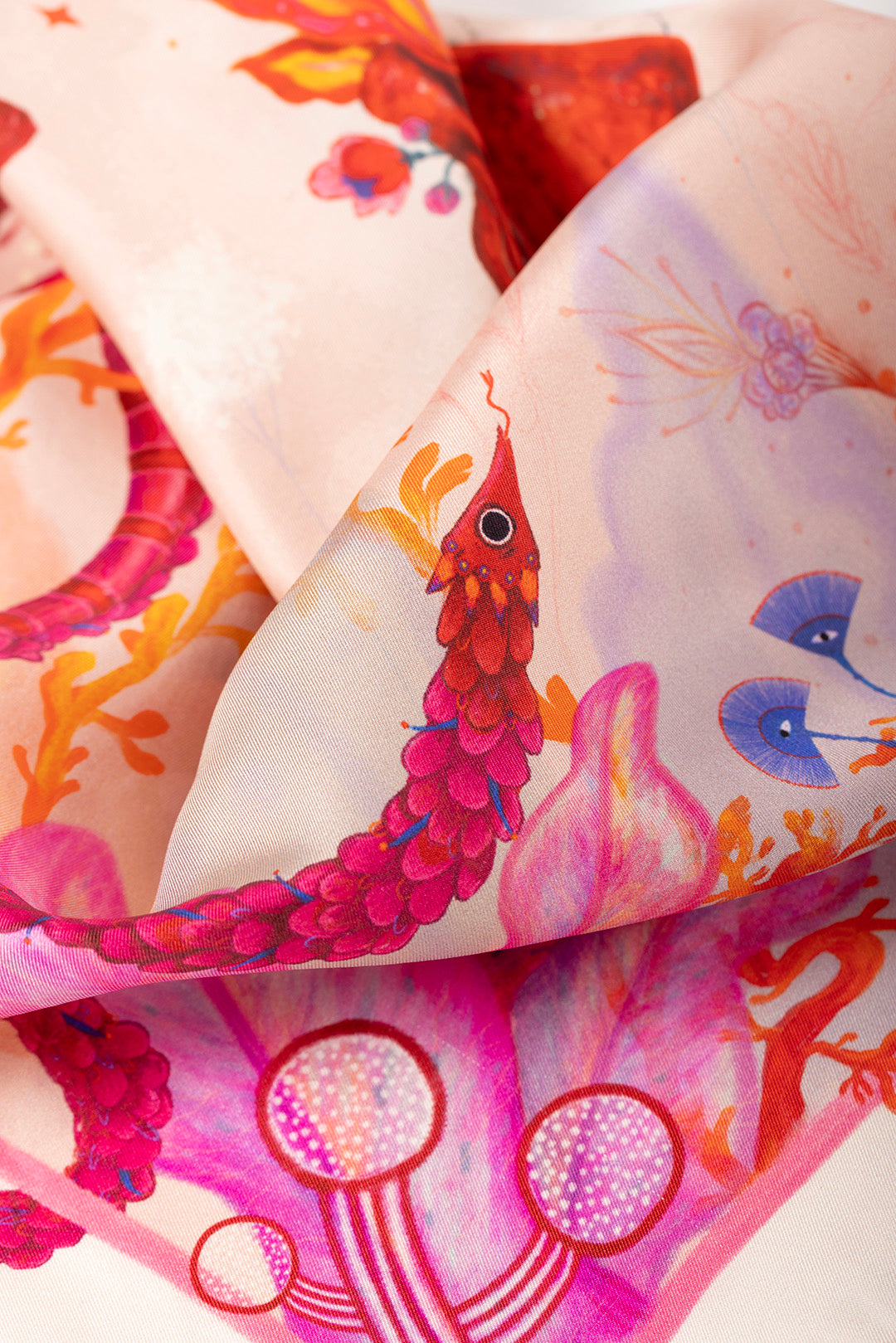Luxury silk scarf by Journey of Yula, featuring unique surrealist art, flaming heart motif, and mythical creature illustrations. High-end wearable art accessory for women.