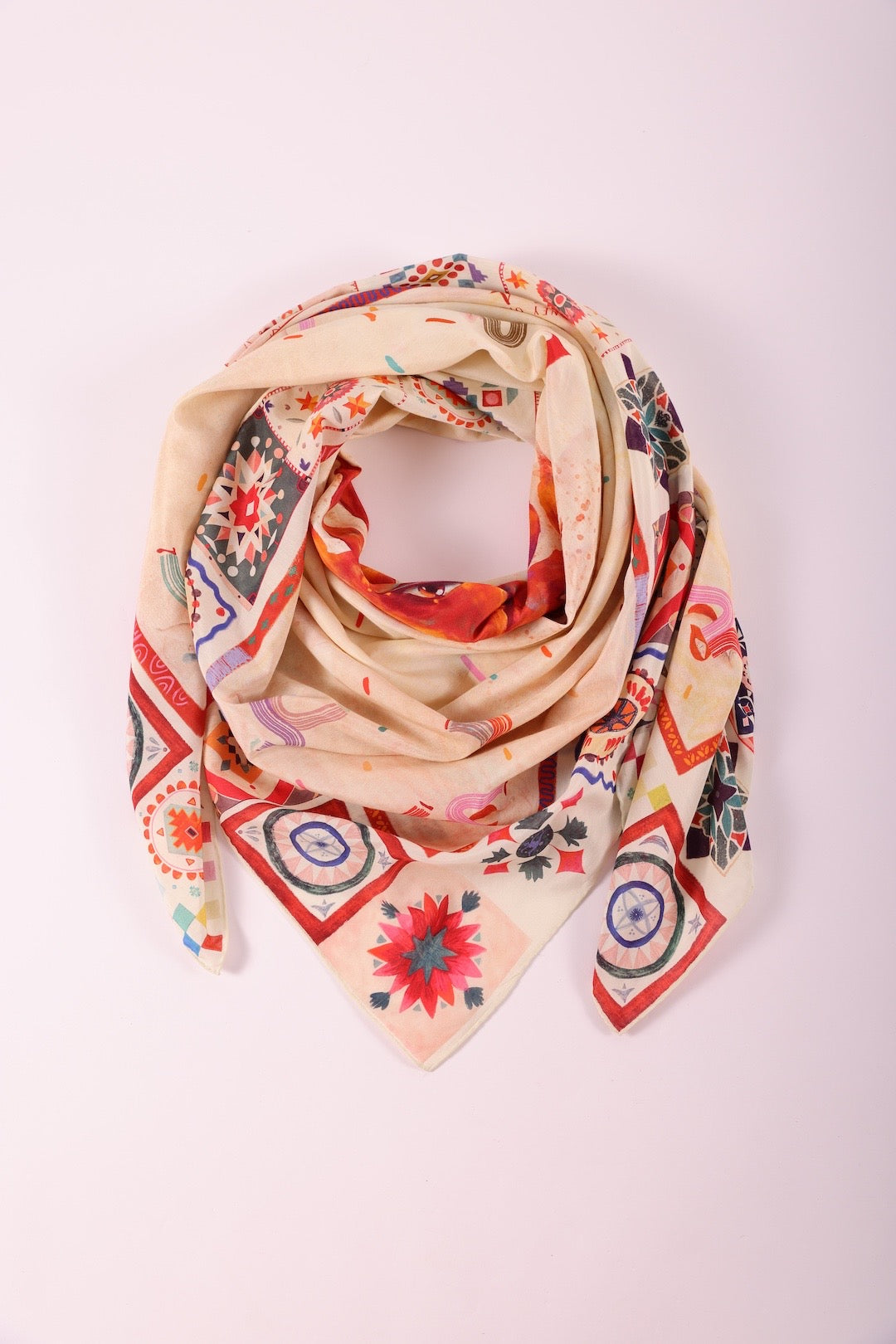 Journey of Yula luxury silk scarf with sun motif and ethnic borders displayed on a clean background.