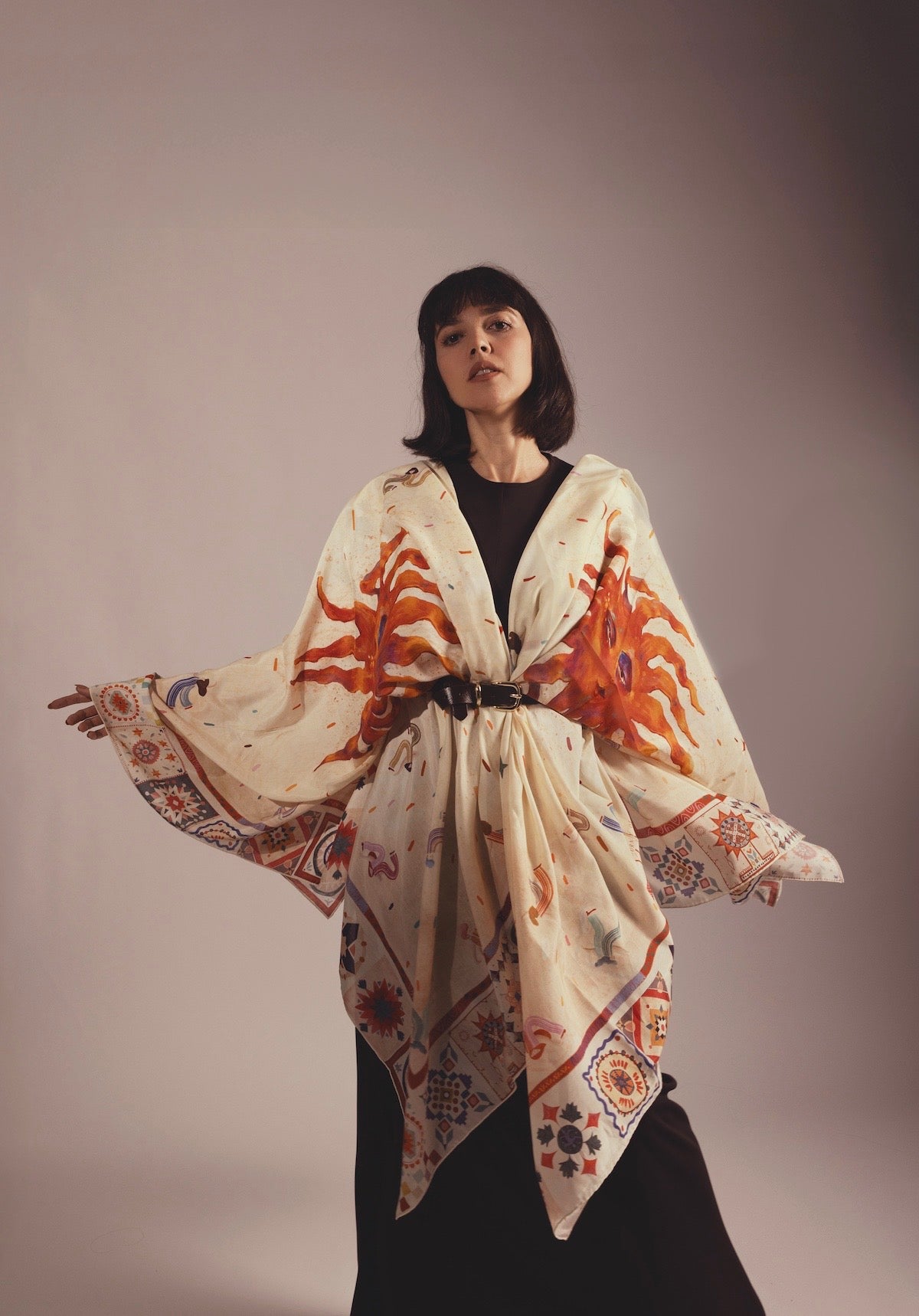 Model wearing a Journey of Yula silk scarf styled as a luxury kimono wrap with a belt.