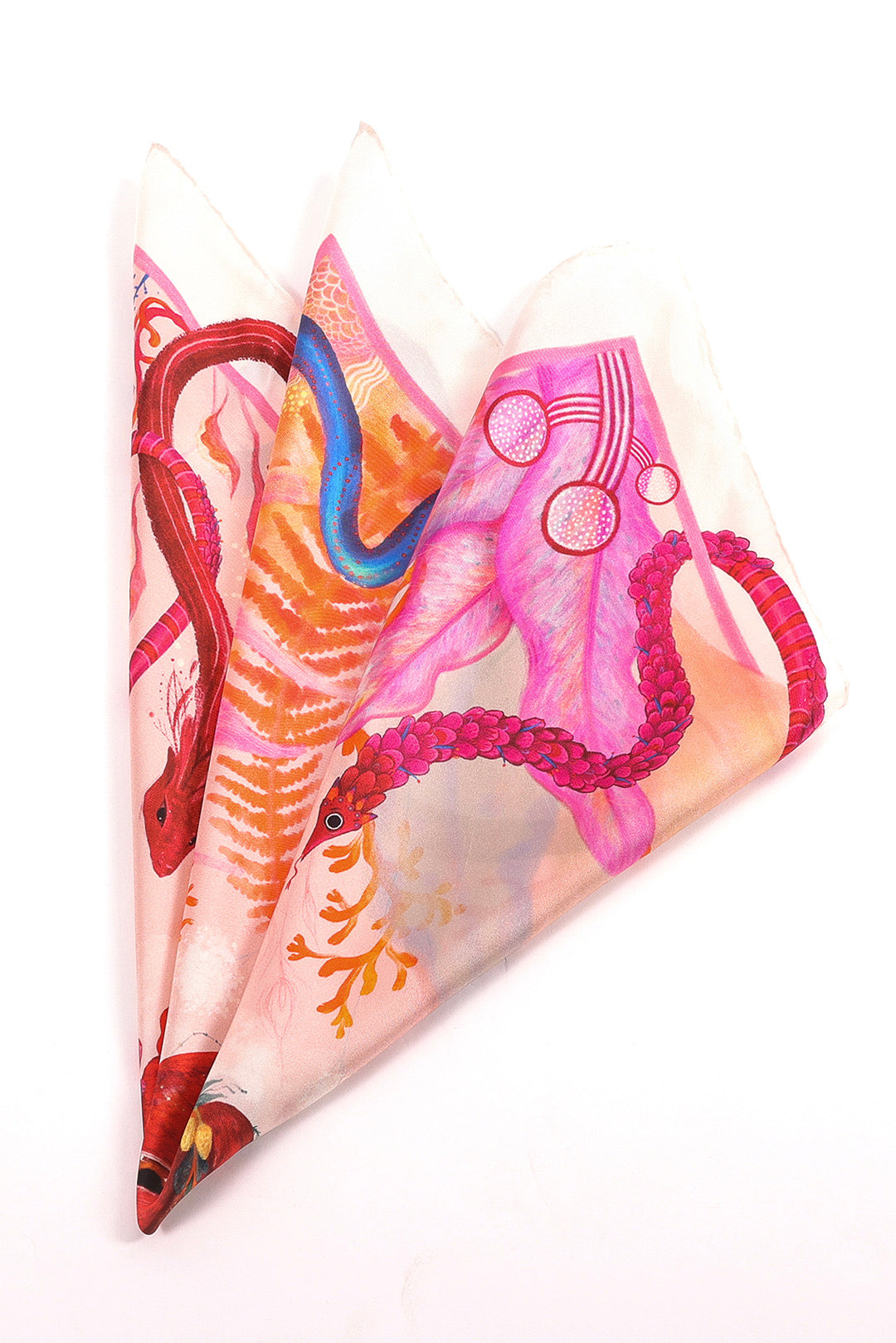 Heart Aflame" silk scarf folded into three points, showcasing the gradient of pink, red, and blue mythical serpent patterns.