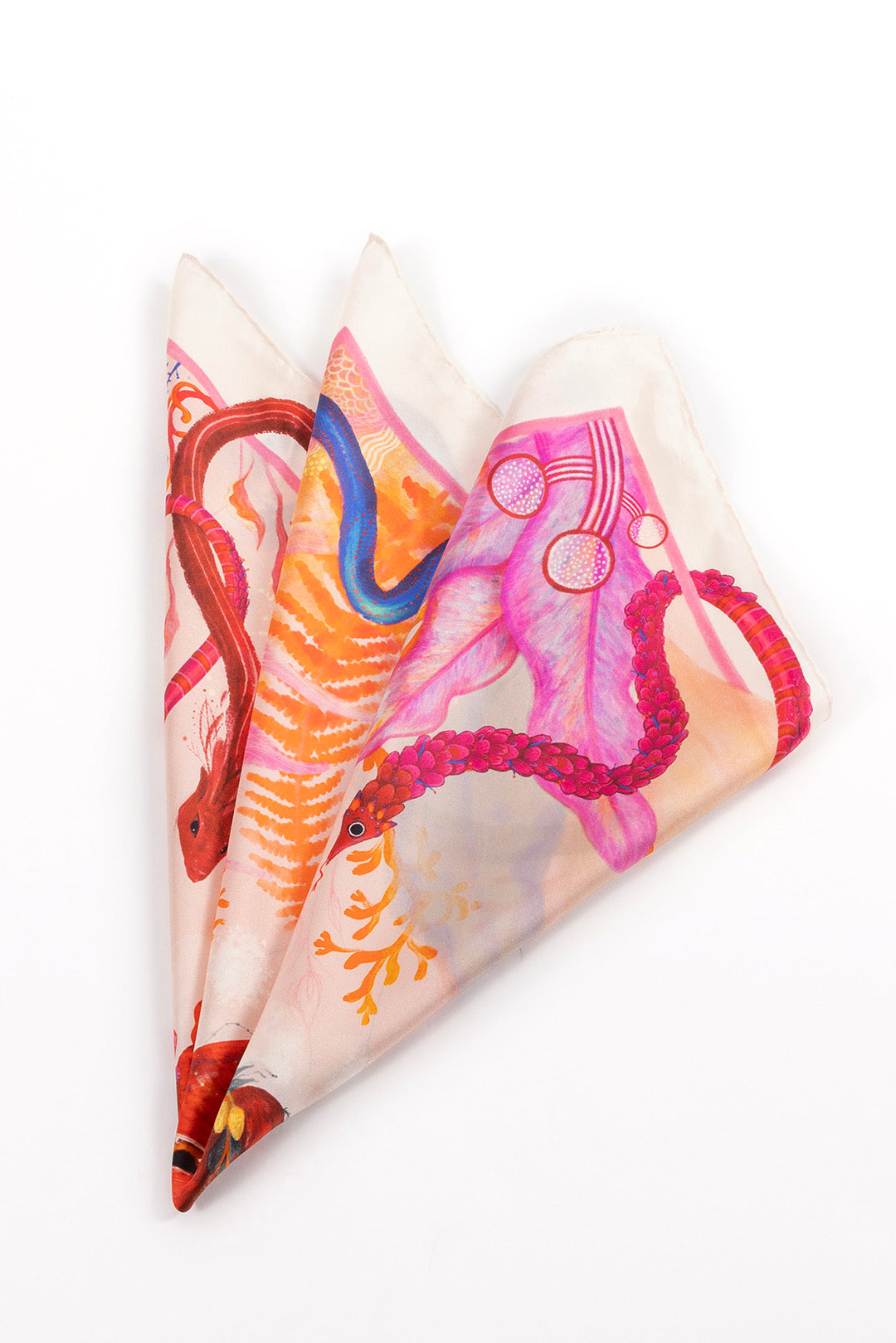 A close-up of the scarf folded into multiple triangular layers, showcasing the detailed textures of the dragon scales and botanical elements.