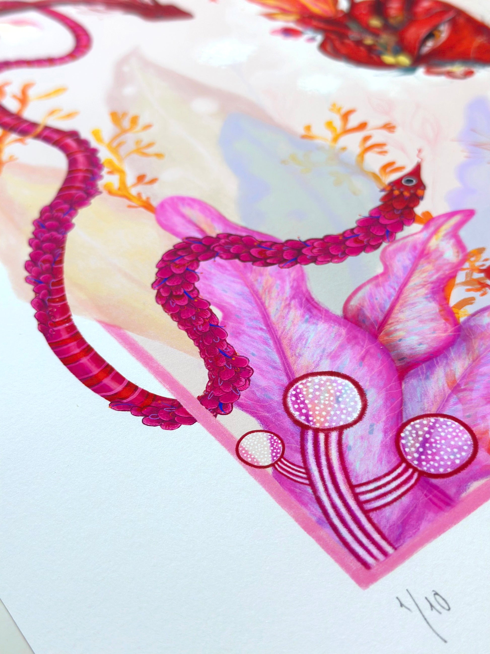 A high-quality art print titled "Heart Aflame" by Elif, featuring a surreal anatomical heart with a central eye and flames, surrounded by vibrant pink and  botanical elements.